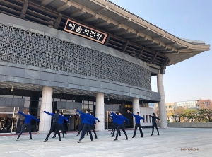 Due to limited space inside the Cheongju Art Center, rehearsal is moved to the plaza outside. Dancers synchronize their moves in front of the theater&rsquo;s reflective glass doors&mdash;they make pretty good mirrors!